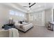 Bright main bedroom with a king-sized bed, large windows and ceiling fan, showcasing natural light at 604 Whistable Ave, Wake Forest, NC 27587