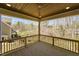 A covered porch with wooden floors and ceilings overlooking the backyard and surrounding trees at 604 Whistable Ave, Wake Forest, NC 27587