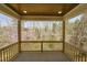 A covered porch with wooden floors and railings offers a lovely view of the surrounding landscape at 604 Whistable Ave, Wake Forest, NC 27587