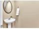 Powder room with a pedestal sink, oval mirror and towel ring at 627 Nixon Dr, Sanford, NC 27330