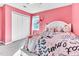 Bright bedroom features pink walls, closet and a large window at 627 Nixon Dr, Sanford, NC 27330
