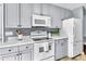Bright kitchen area featuring white appliances and generous counter space at 627 Nixon Dr, Sanford, NC 27330