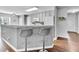 Kitchen with gray walls and cabinets, with a breakfast bar featuring two bar stools at 627 Nixon Dr, Sanford, NC 27330