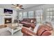 Cozy living room with fireplace and a large window that offers great natural lighting at 627 Nixon Dr, Sanford, NC 27330