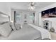 Large main bedroom featuring three windows and a mounted flat screen TV at 627 Nixon Dr, Sanford, NC 27330