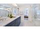 Modern bathroom featuring a dual-sink vanity, large mirror, glass-enclosed shower, and neutral finishes at 664 Sun Meadow Dr, Wake Forest, NC 27587