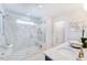 Bathroom featuring a tiled shower with a glass door, window, built-in bench and modern sink with vanity at 664 Sun Meadow Dr, Wake Forest, NC 27587