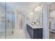 Modern bathroom featuring a dual-sink vanity, large mirror, glass-enclosed shower, and a walk-in closet at 664 Sun Meadow Dr, Wake Forest, NC 27587