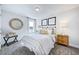 Cozy bedroom featuring a comfortable bed, stylish decor, and a bright window at 664 Sun Meadow Dr, Wake Forest, NC 27587