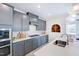 Modern kitchen design featuring gray cabinets, a white subway tile backsplash, and stainless steel appliances at 664 Sun Meadow Dr, Wake Forest, NC 27587