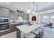 Spacious kitchen with a center island, seating, modern appliances, and stylish pendant lighting at 664 Sun Meadow Dr, Wake Forest, NC 27587