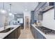 Modern kitchen features stainless steel appliances, gray cabinetry, and an open layout at 664 Sun Meadow Dr, Wake Forest, NC 27587