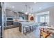 Gourmet kitchen featuring gray cabinets, stainless steel appliances, and a large center island with seating at 664 Sun Meadow Dr, Wake Forest, NC 27587