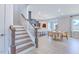 Open-concept living area with staircase, dining area, kitchen and ample seating at 664 Sun Meadow Dr, Wake Forest, NC 27587