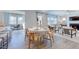 Open-concept living area with dining table, fireplace, and large windows provides ample natural light at 664 Sun Meadow Dr, Wake Forest, NC 27587