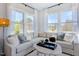 Comfortable living room featuring a sectional sofa, ample windows, and stylish decor at 664 Sun Meadow Dr, Wake Forest, NC 27587