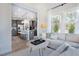 Bright living room with gray cabinets, stainless steel appliances, island seating, and an open layout at 664 Sun Meadow Dr, Wake Forest, NC 27587