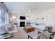 Bright living room features ceiling fan, a fireplace, comfortable sofas, and contemporary furnishings at 664 Sun Meadow Dr, Wake Forest, NC 27587