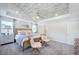 Spacious bedroom with a tray ceiling, ceiling fan, neutral decor, and large windows for natural light at 664 Sun Meadow Dr, Wake Forest, NC 27587
