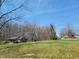 Single-story brick home on a large, sunny lot with mature trees at 707 Dickens St, Roxboro, NC 27573