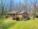Exterior view of charming brick home with covered porch and accessible ramp at 707 Dickens St, Roxboro, NC 27573