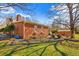 Brick home with a large backyard featuring mature trees and a shed at 712 Springwood Ave, Gibsonville, NC 27249