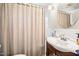 Bathroom with tile backsplash, shower curtain, round mirror and a pedestal sink at 712 Springwood Ave, Gibsonville, NC 27249