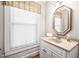 Compact bathroom features a vanity with a unique mirror and natural light at 712 Springwood Ave, Gibsonville, NC 27249