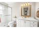Bright bathroom with large vanity, framed mirror and glass enclosed shower at 712 Springwood Ave, Gibsonville, NC 27249