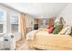 Bright bedroom with twin beds, curtains and several large windows at 712 Springwood Ave, Gibsonville, NC 27249