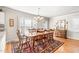 Dining room with hardwood floors, a large wooden table and many matching chairs at 712 Springwood Ave, Gibsonville, NC 27249