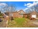 Traditional brick home featuring a well-maintained lawn and mature landscaping at 712 Springwood Ave, Gibsonville, NC 27249