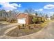 A brick home with mature landscaping and a driveway leading to an attached garage at 712 Springwood Ave, Gibsonville, NC 27249