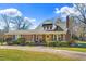 Charming brick home with a yellow front door, manicured bushes, and a well-maintained lawn at 712 Springwood Ave, Gibsonville, NC 27249