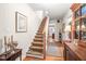 Hallway and staircase with wood floors, elegant runner, and decorative artwork at 712 Springwood Ave, Gibsonville, NC 27249