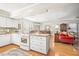 Open-concept kitchen with island and views to the dining and living area at 712 Springwood Ave, Gibsonville, NC 27249