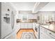 Bright kitchen with white cabinets, granite countertops, and a full-size refrigerator at 712 Springwood Ave, Gibsonville, NC 27249