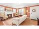Warm living room with a fireplace, hardwood floors, and elegant furniture at 712 Springwood Ave, Gibsonville, NC 27249