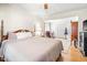 Spacious main bedroom with sitting area, neutral colors and hardwood floors at 712 Springwood Ave, Gibsonville, NC 27249