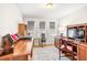 Well-lit office with hardwood floors, built-in bookshelves and large windows at 712 Springwood Ave, Gibsonville, NC 27249