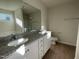 Bathroom featuring double sink vanity with granite countertop and modern fixtures at 72 Heatherglenn Cir, Princeton, NC 27569