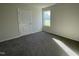 Bedroom featuring neutral walls, plush carpet, and a window that provides natural light at 72 Heatherglenn Cir, Princeton, NC 27569