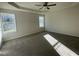 Large main bedroom with plush carpeting, two windows, and tray ceiling, a tranquil retreat for relaxation and rest at 72 Heatherglenn Cir, Princeton, NC 27569