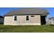 Exterior view of the home showcasing the siding, foundation, and lush green backyard at 72 Heatherglenn Cir, Princeton, NC 27569