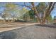 Expansive, fenced backyard featuring mature trees and ample space for outdoor activities and gardening at 7604 Derek Dr, Raleigh, NC 27613