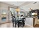 Bright dining room with a glass-top table and views into the living room and backyard at 7604 Derek Dr, Raleigh, NC 27613
