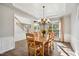 Sunlit dining room with wood table, chairs, and coffered ceiling at 7604 Derek Dr, Raleigh, NC 27613