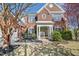 Beautiful brick home with a welcoming entrance, bench, and garden at 7604 Derek Dr, Raleigh, NC 27613