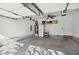 Spacious garage with ceiling fan, storage shelves, water heater, and room for parking at 7604 Derek Dr, Raleigh, NC 27613