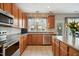 Functional kitchen featuring modern stainless steel appliances, wood cabinetry, and ample counter space at 7604 Derek Dr, Raleigh, NC 27613